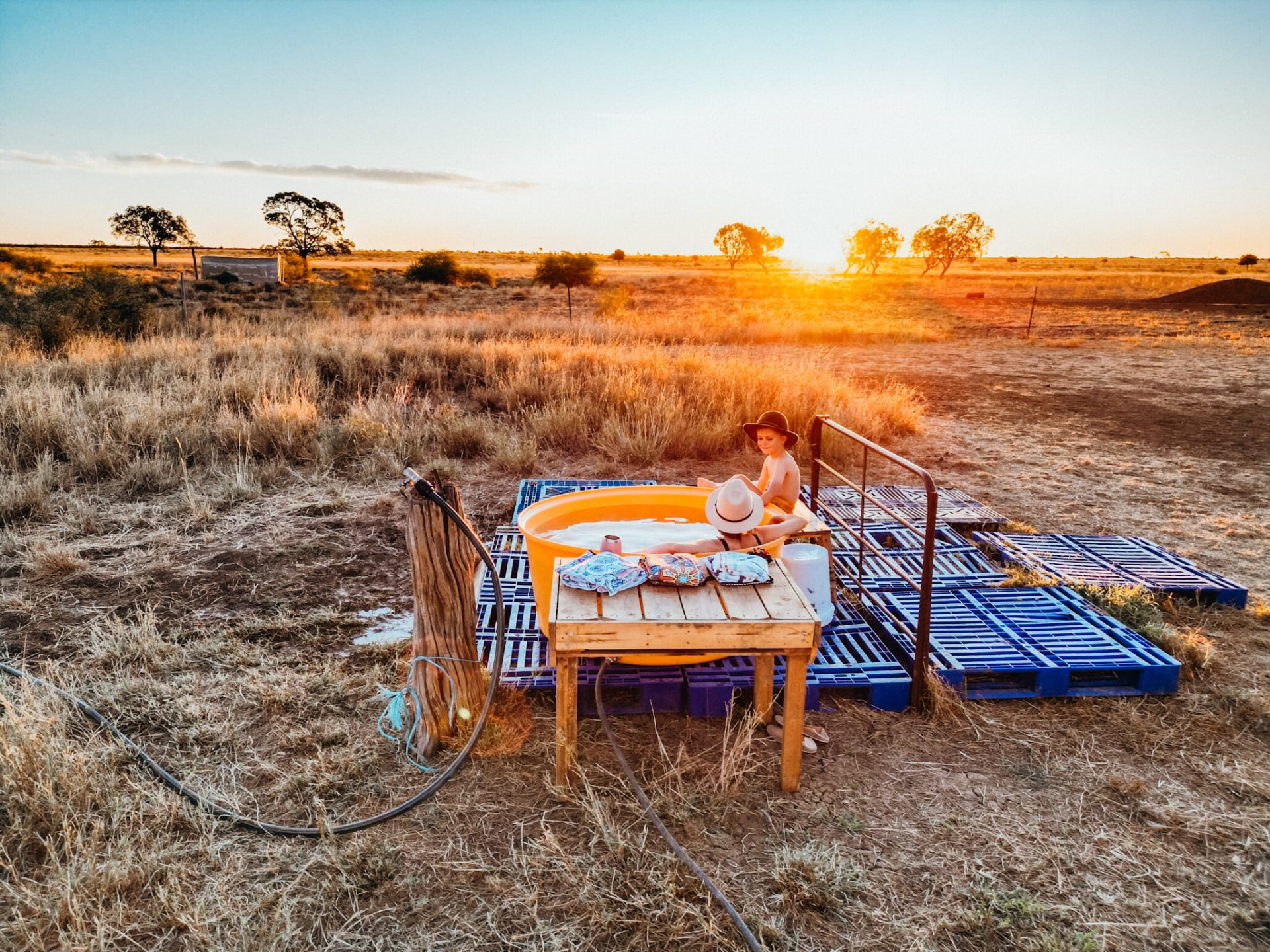 The Feel Good Family enjoying an outdoor bath at an Outback Queensland farmstay