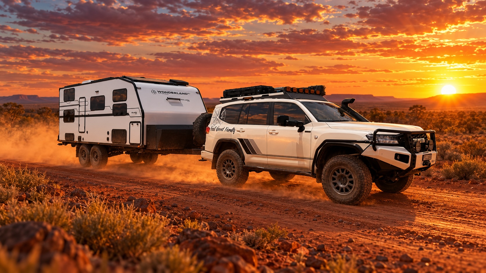 The Feel Good Family 4WD towing the van along a red dirt outback track at sunset