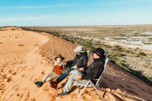 default Family sitting on top of Big Red Sand Dune Simpson Desert, Outback Queensland