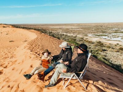 default Family sitting on top of Big Red Sand Dune Simpson Desert, Outback Queensland